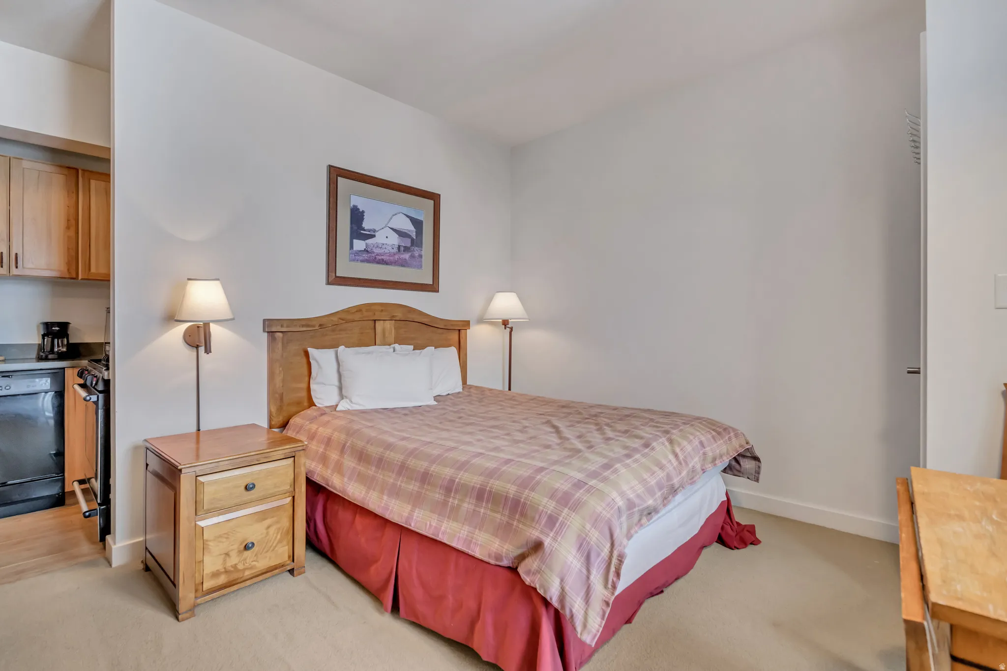 Bedroom featuring light colored carpet