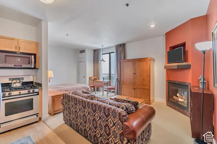 Living area with a glass covered fireplace and baseboards