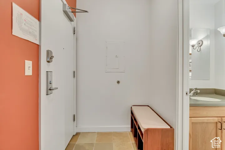 Bathroom featuring vanity, electric panel, and light tile patterned floors