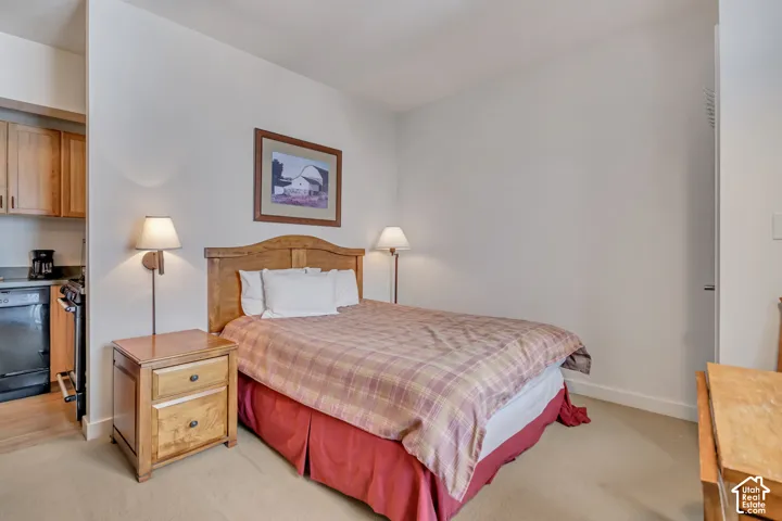 Bedroom featuring light colored carpet