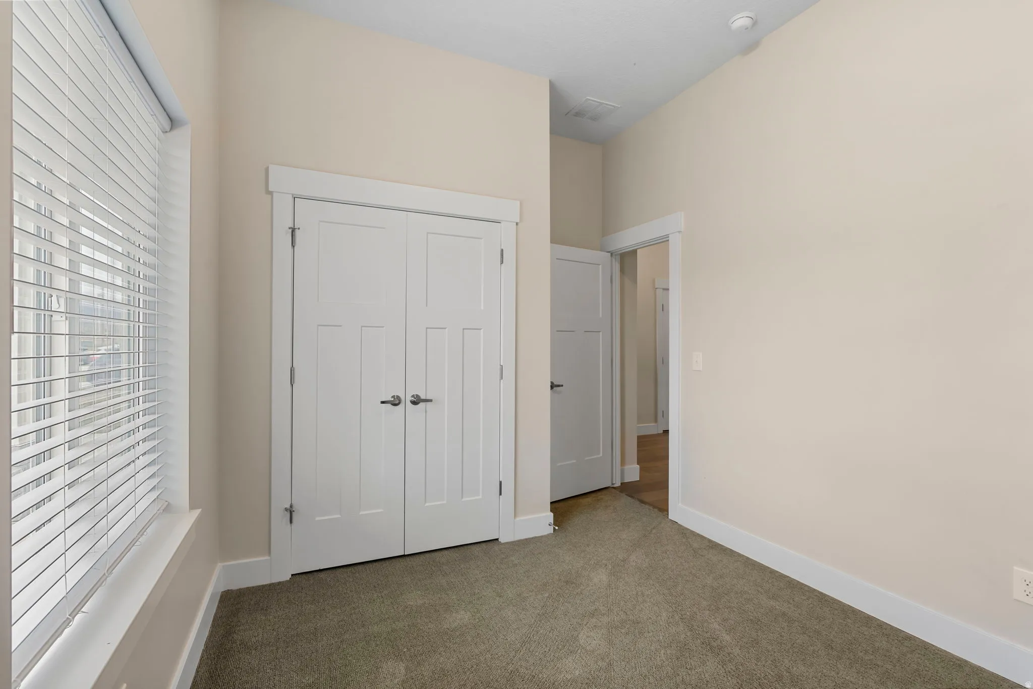 Unfurnished bedroom with carpet flooring and a closet