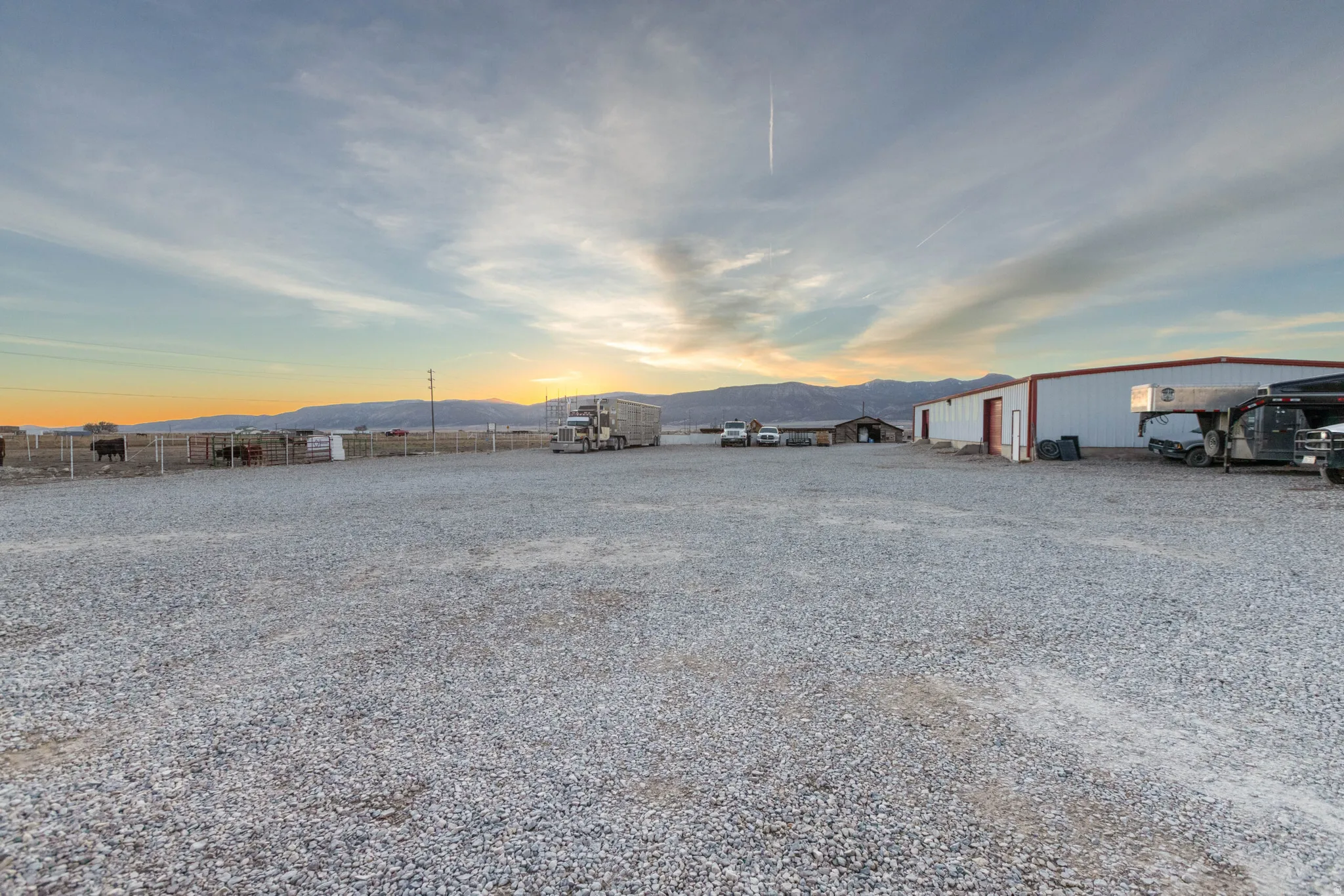 Yard at dusk featuring a mountain view and an outdoor structure