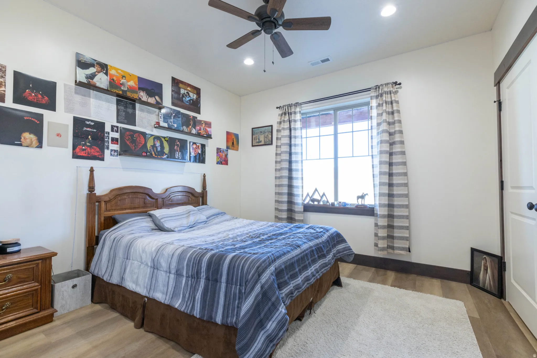 Bedroom with light wood finished floors, recessed lighting, and ceiling fan