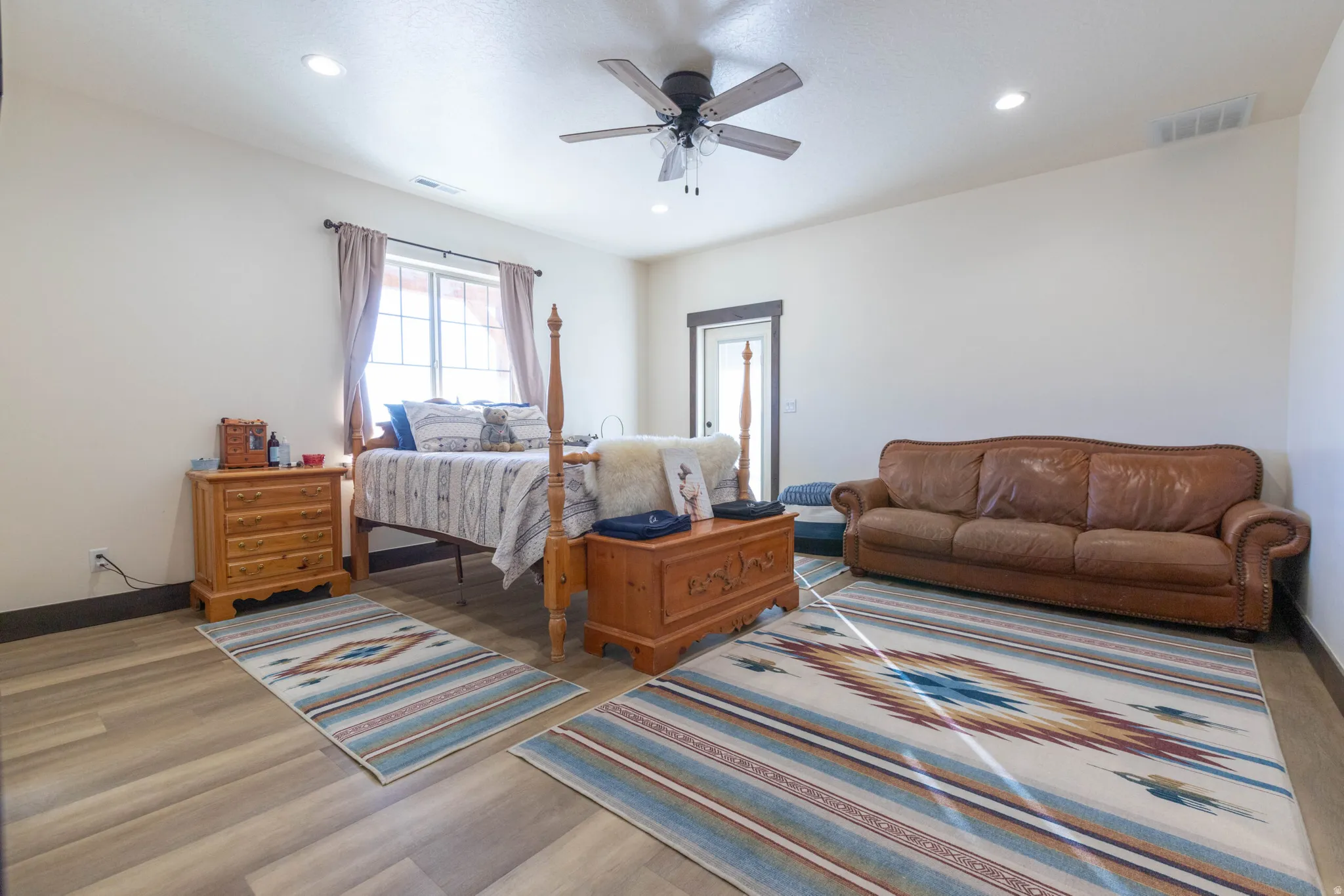 Bedroom with wood finished floors, recessed lighting, and a ceiling fan