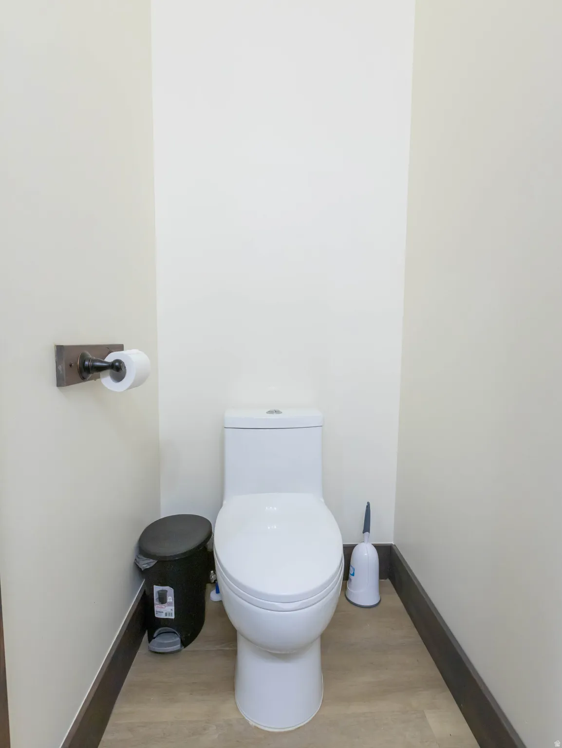 Bathroom with toilet and light wood-style floors