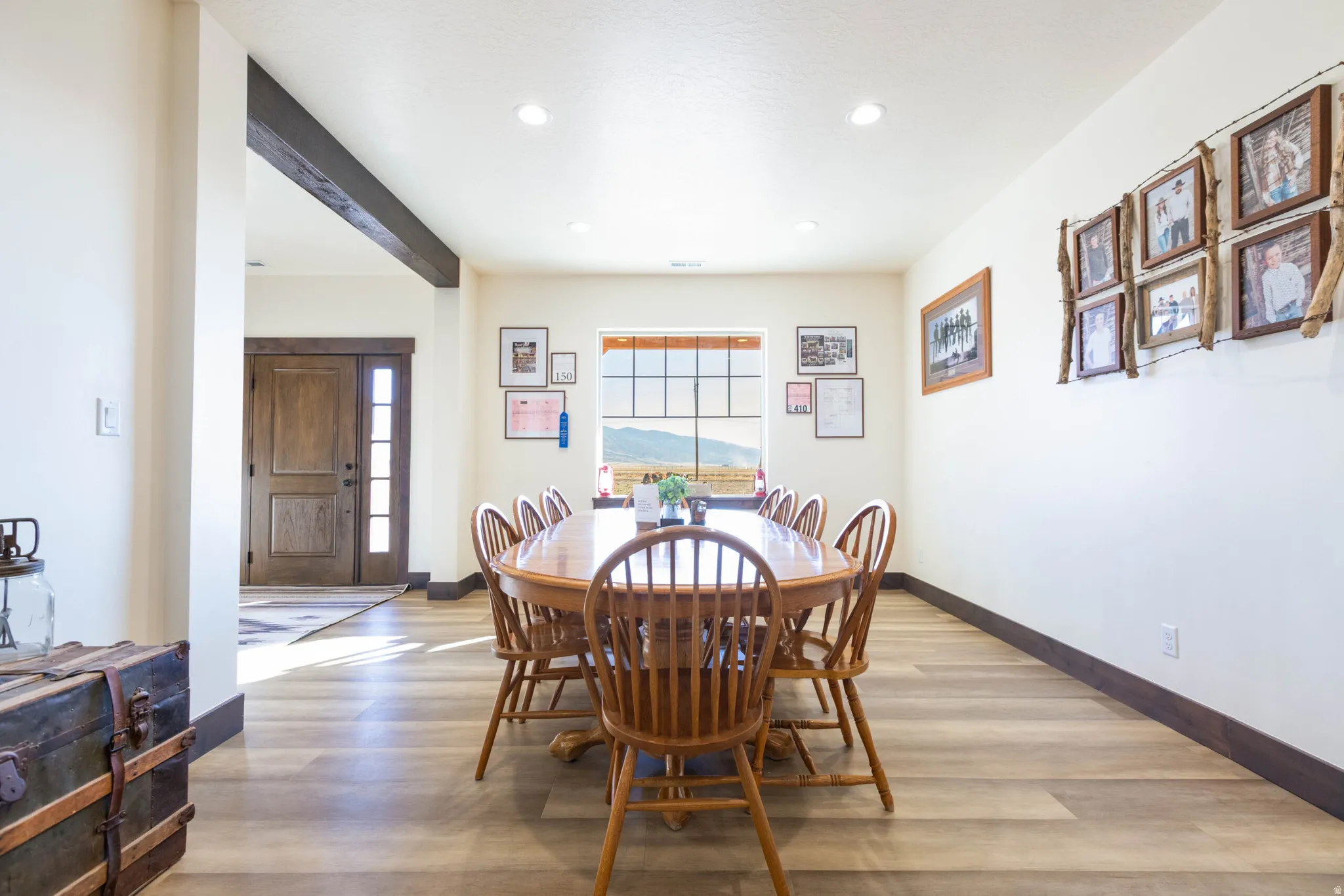 Dining space with light wood finished floors and recessed lighting