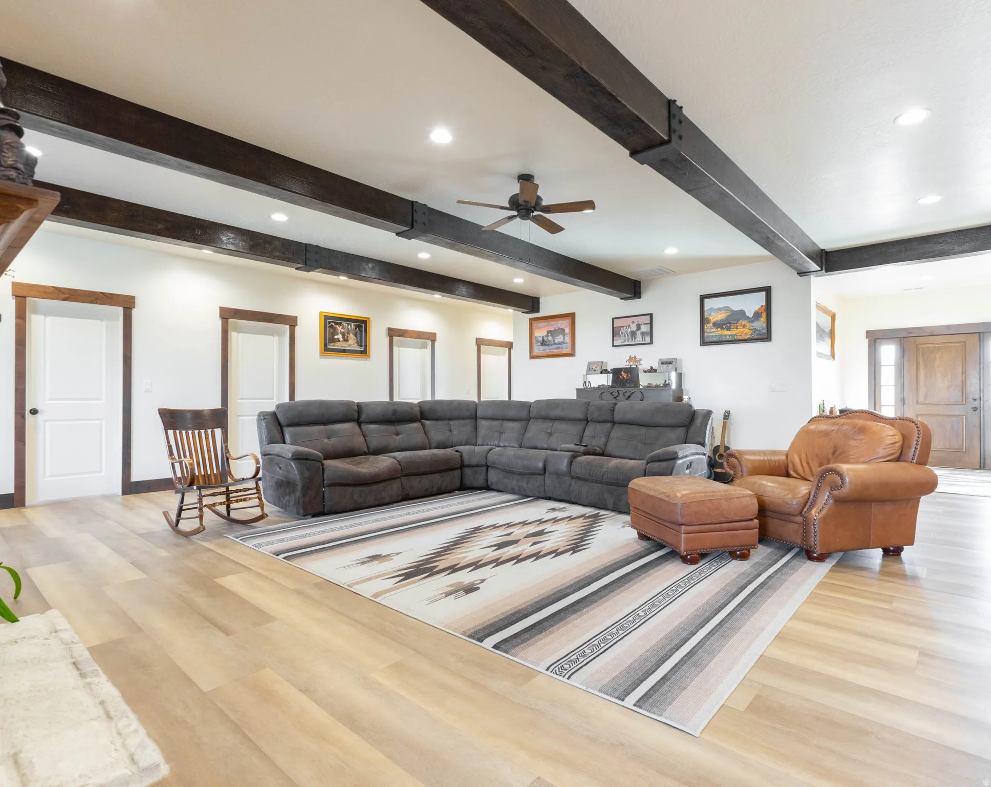 Living area featuring a ceiling fan, wood finished floors, recessed lighting, and beamed ceiling