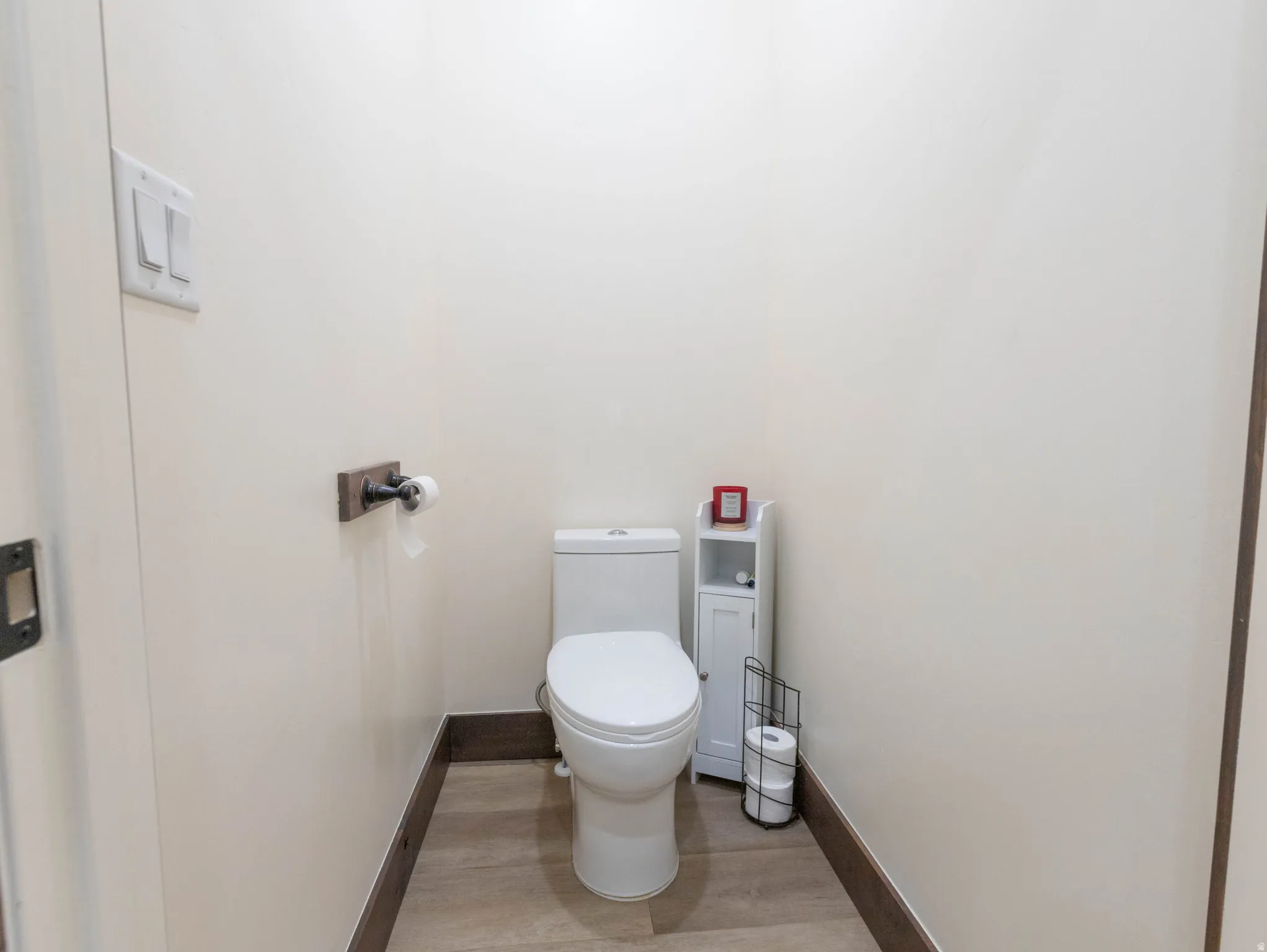 Bathroom featuring toilet and light wood-style flooring