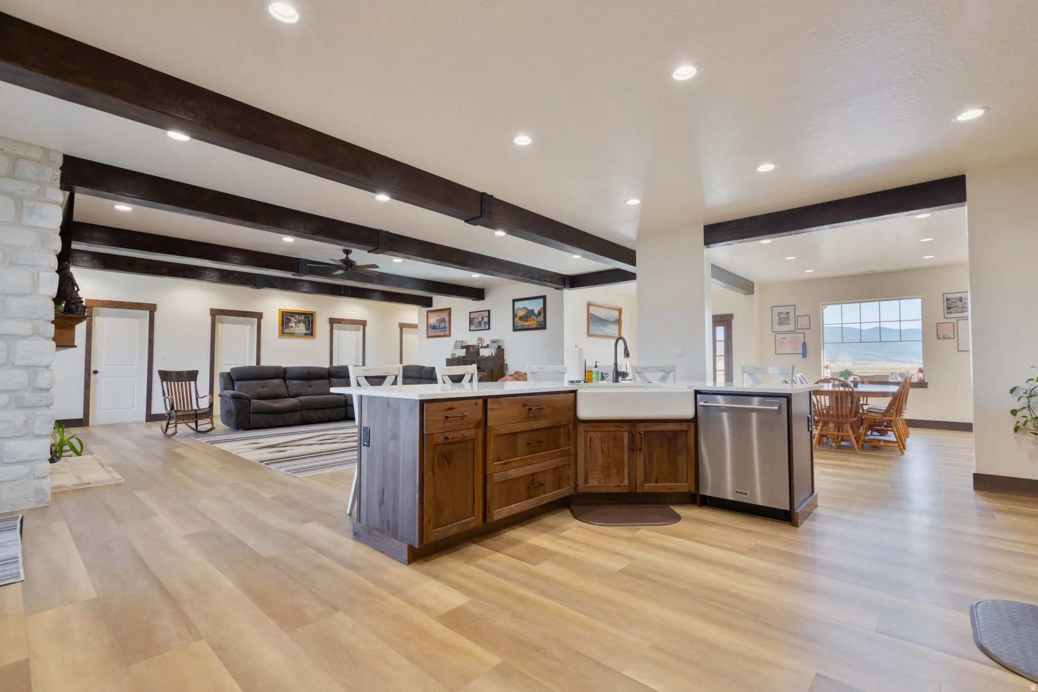 Kitchen with open floor plan, recessed lighting, dishwasher, a ceiling fan, and beam ceiling