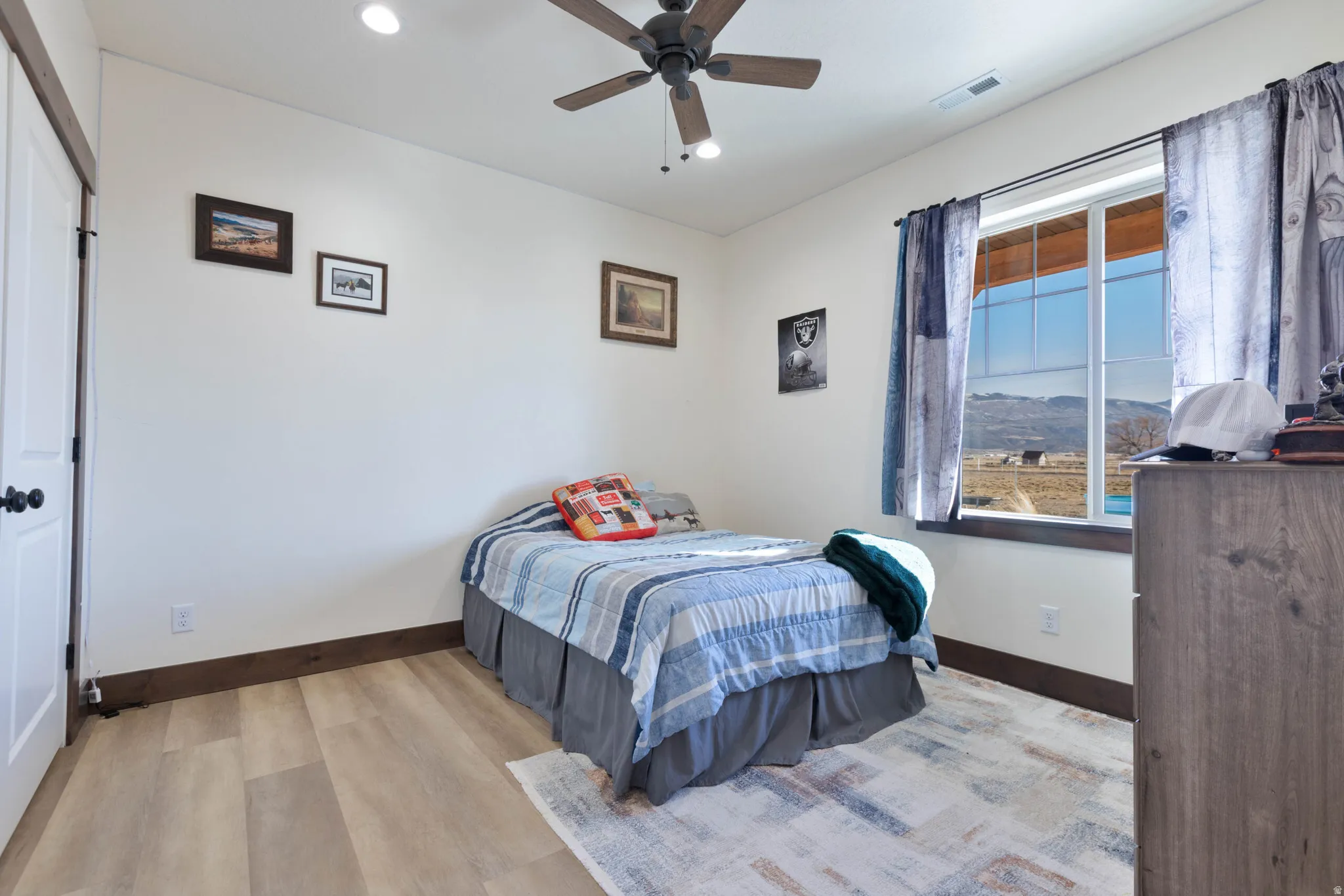 Bedroom with light wood-type flooring, recessed lighting, and a ceiling fan
