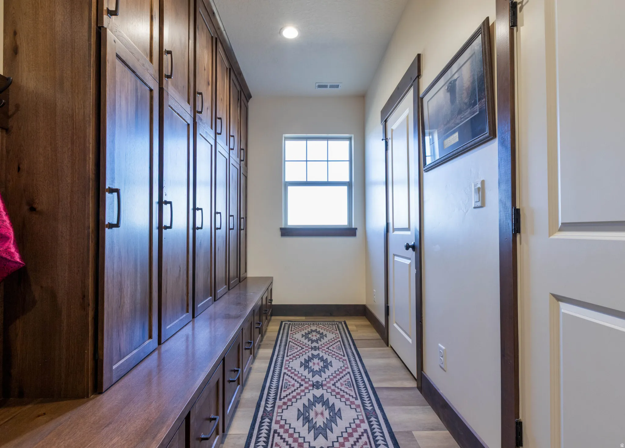 Mudroom with light wood-style flooring and recessed lighting