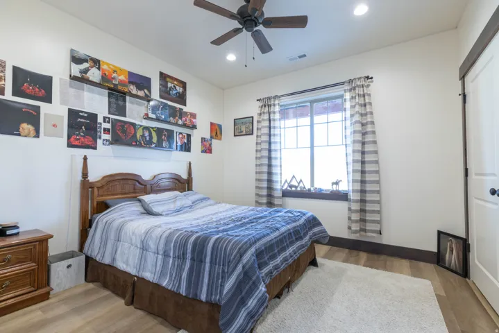 Bedroom with light wood finished floors, recessed lighting, and ceiling fan