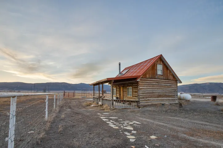 Outdoor structure at dusk featuring a mountain view and a view of rural / pastoral area