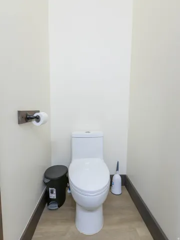 Bathroom with toilet and light wood-style floors