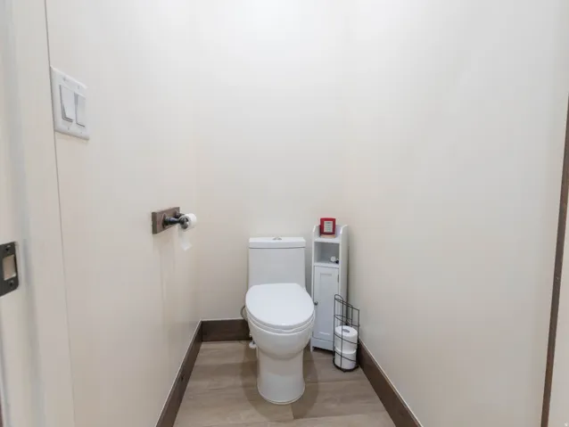 Bathroom featuring toilet and light wood-style flooring