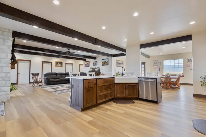 Kitchen with open floor plan, recessed lighting, dishwasher, a ceiling fan, and beam ceiling