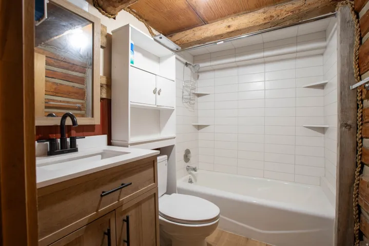 Bathroom with shower / washtub combination and vanity