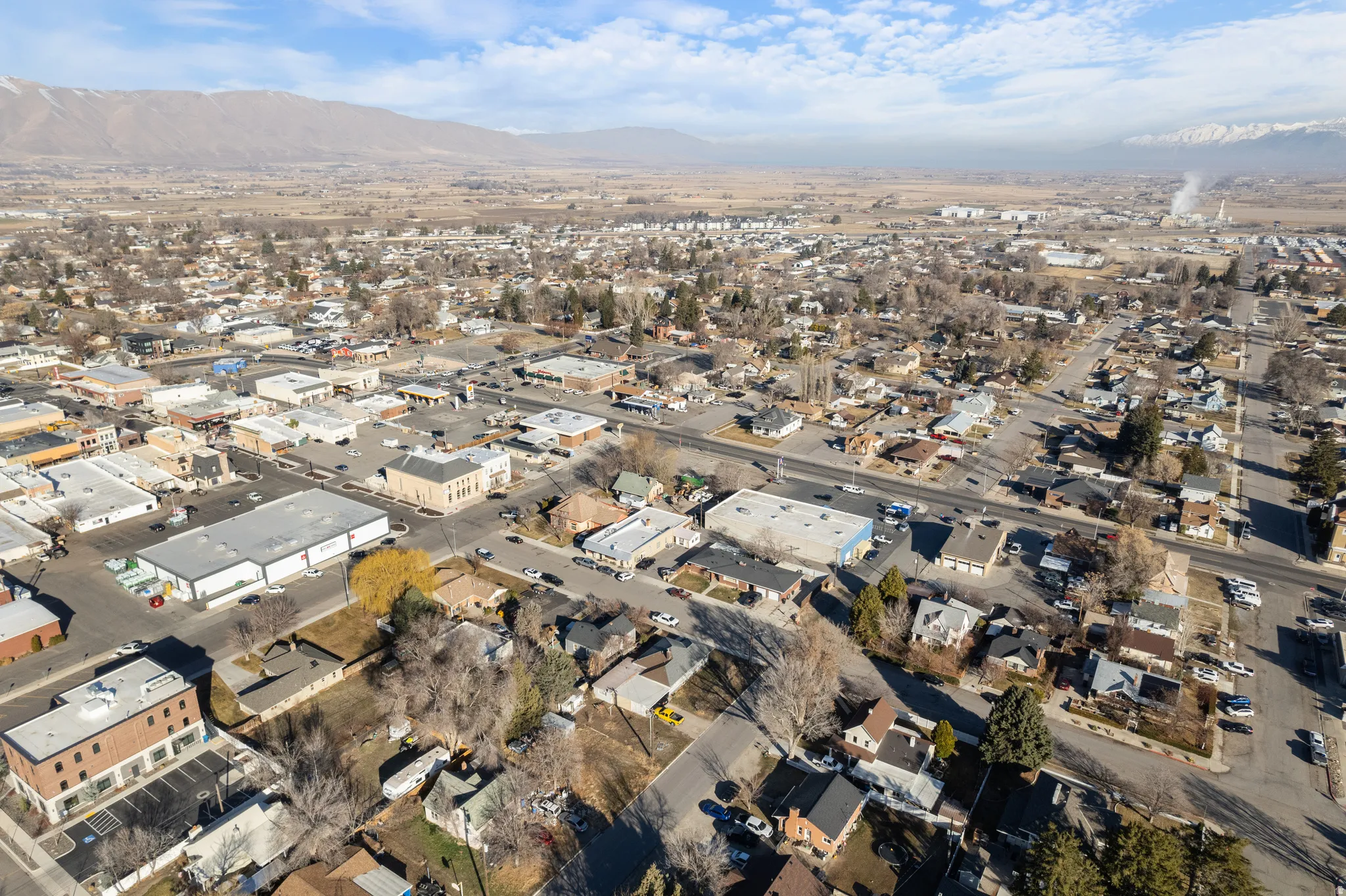 Aerial perspective of suburban area featuring a mountainous background