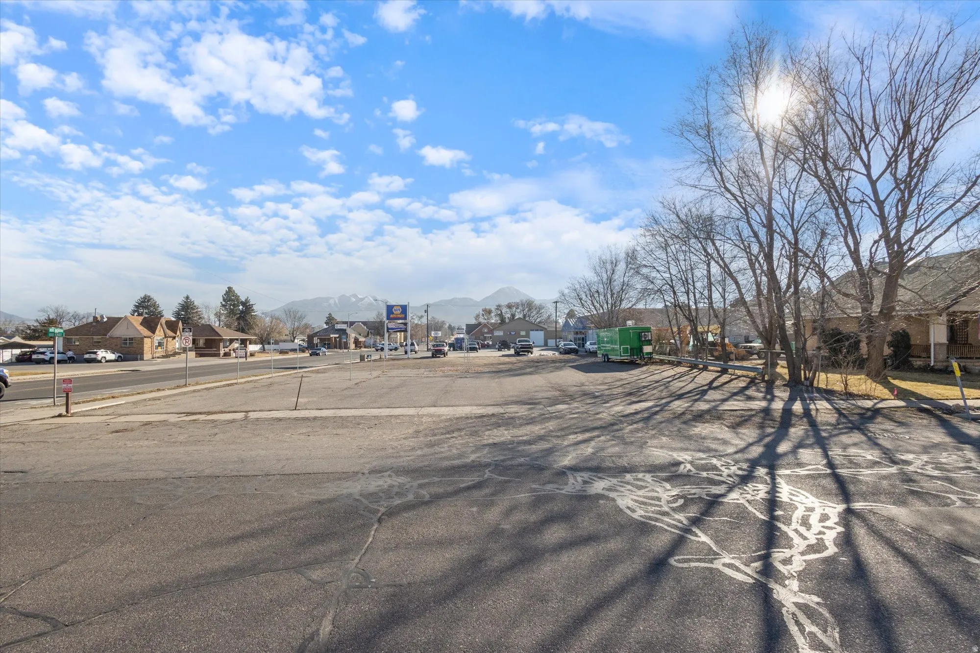 View of asphalt road featuring a residential view, sidewalks, and a mountain view