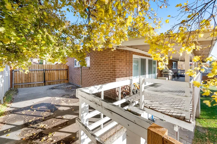 Fenced backyard with a patio and area for grilling
