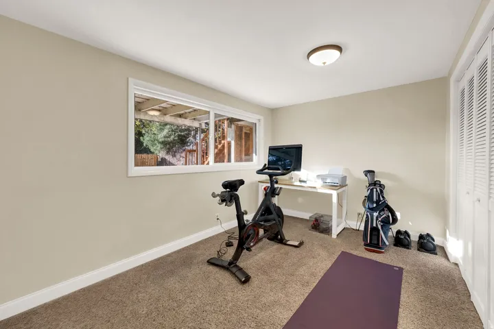 Exercise room with baseboards and carpet floors