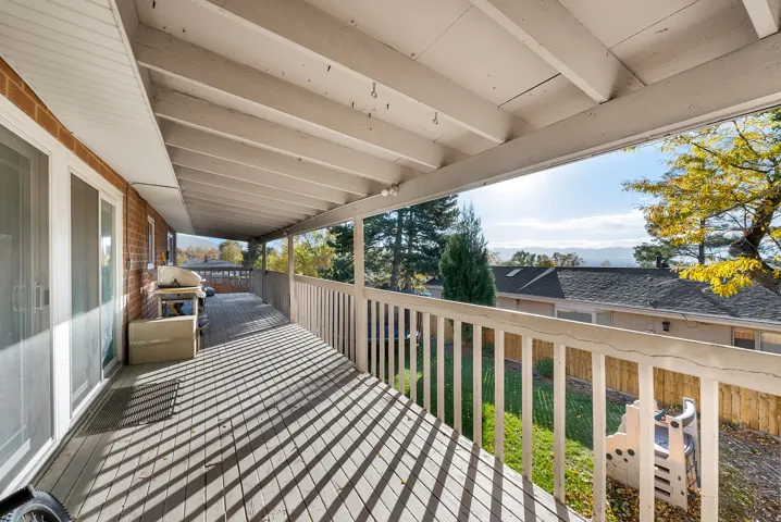 Wooden deck with a lawn and grilling area