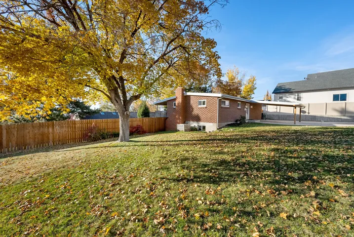 Fenced yard with a patio and an attached carport