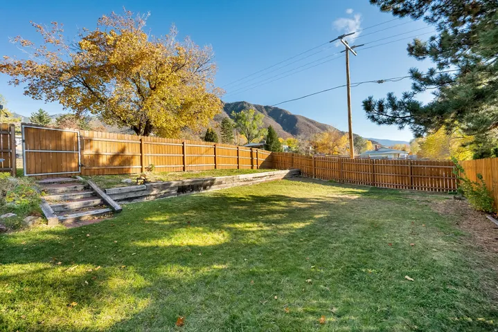 Fenced backyard with a mountain view