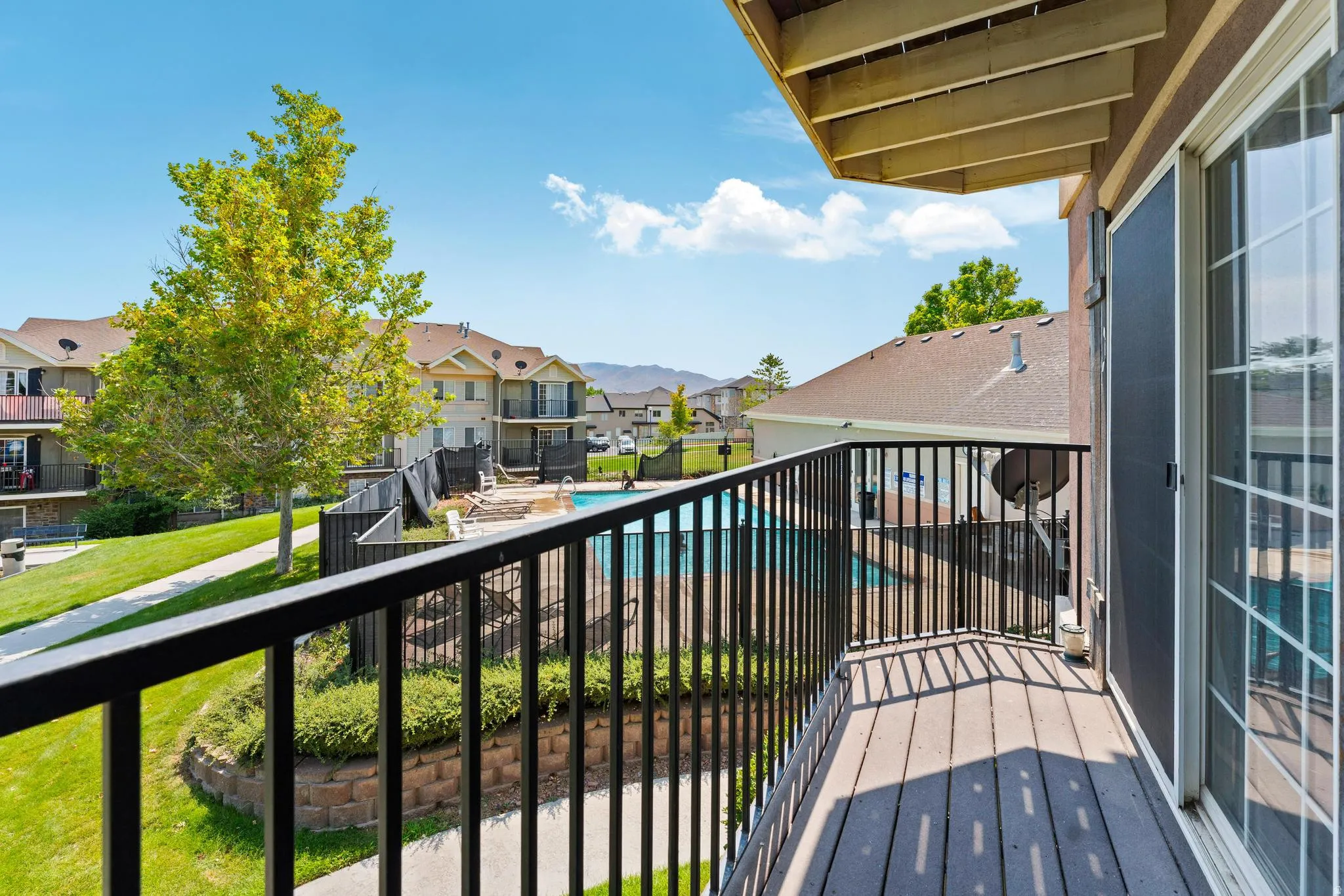 Balcony with view of pool and a residential view