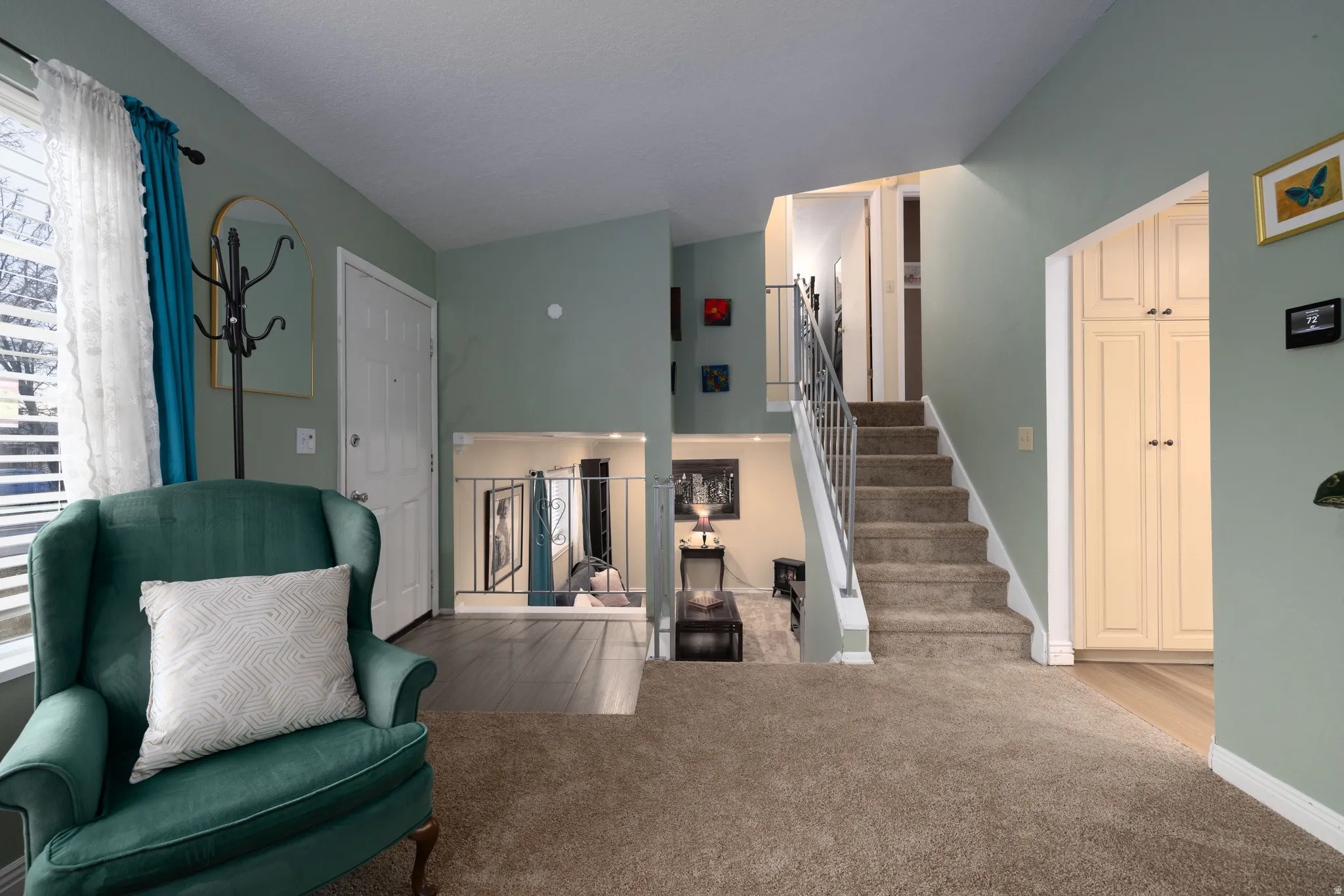 Sitting room with stairs and new carpet flooring