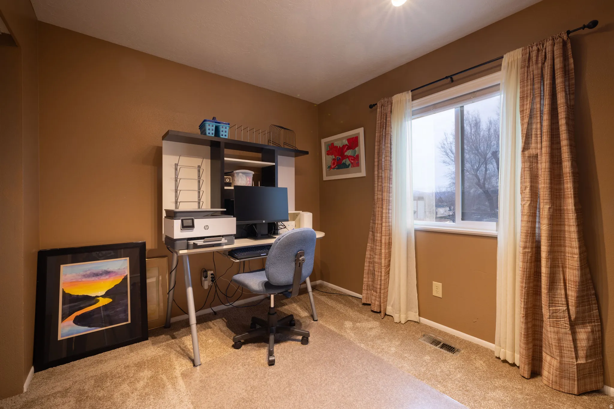 Newly carpeted home office featuring baseboards