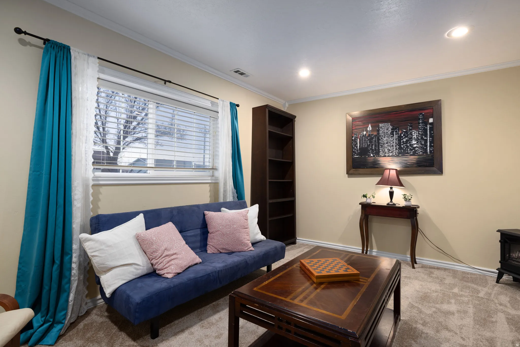 Newly carpeted living area featuring crown molding
