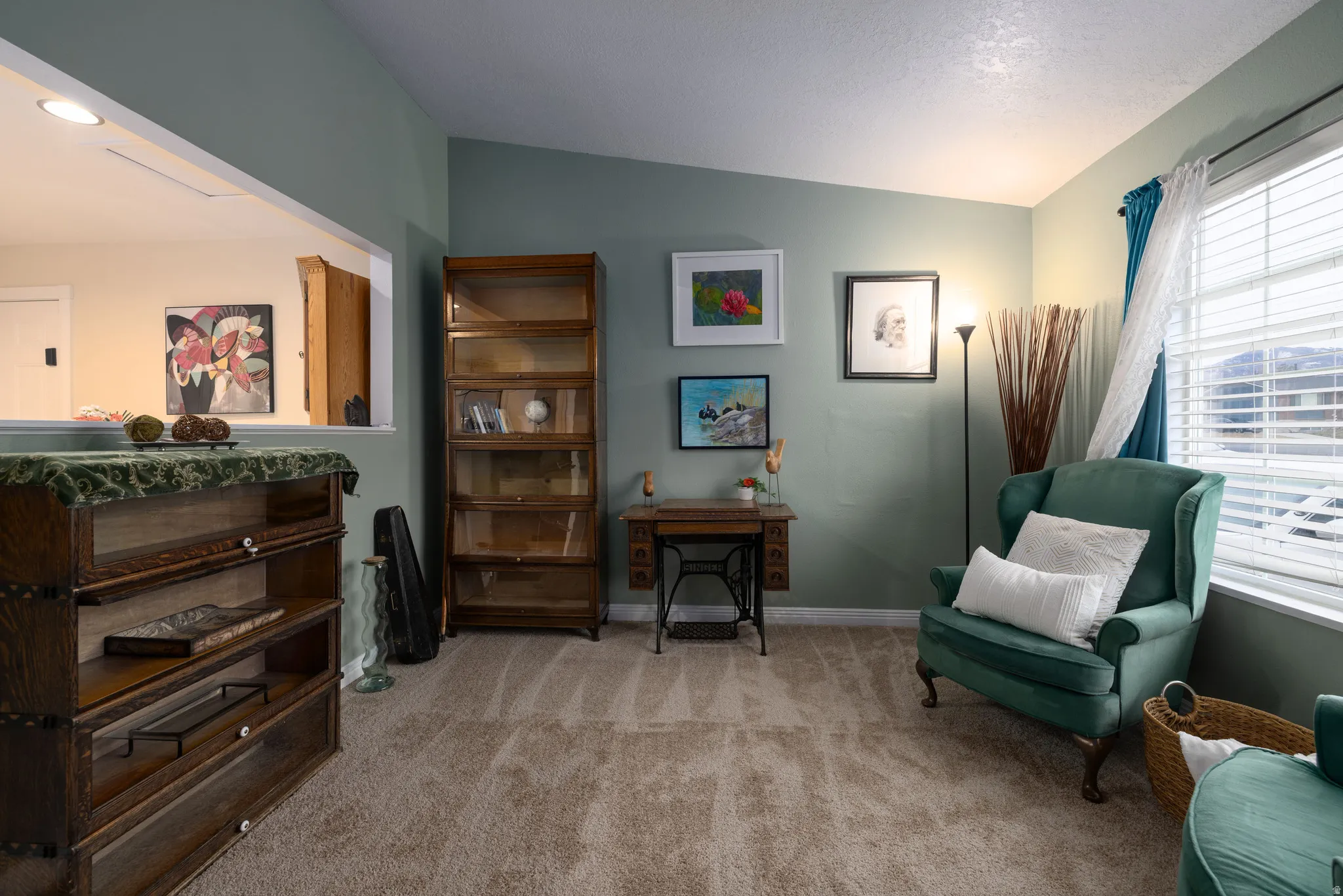 Living area with new light carpet and vaulted ceiling