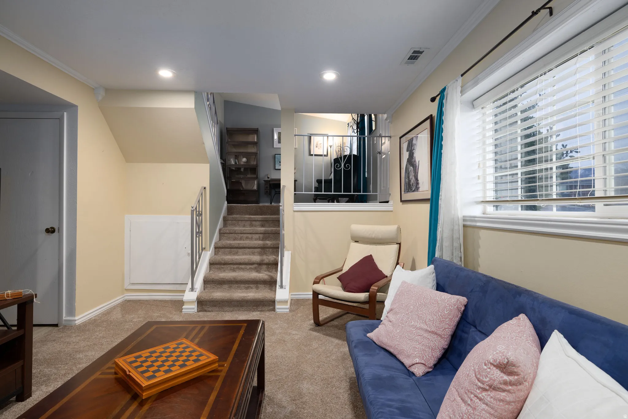 Newly carpeted living room featuring ornamental molding and recessed lighting