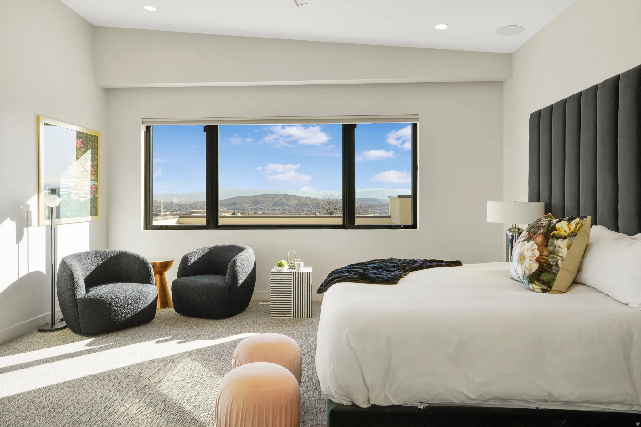 Carpeted bedroom featuring multiple windows, recessed lighting, and a mountain view