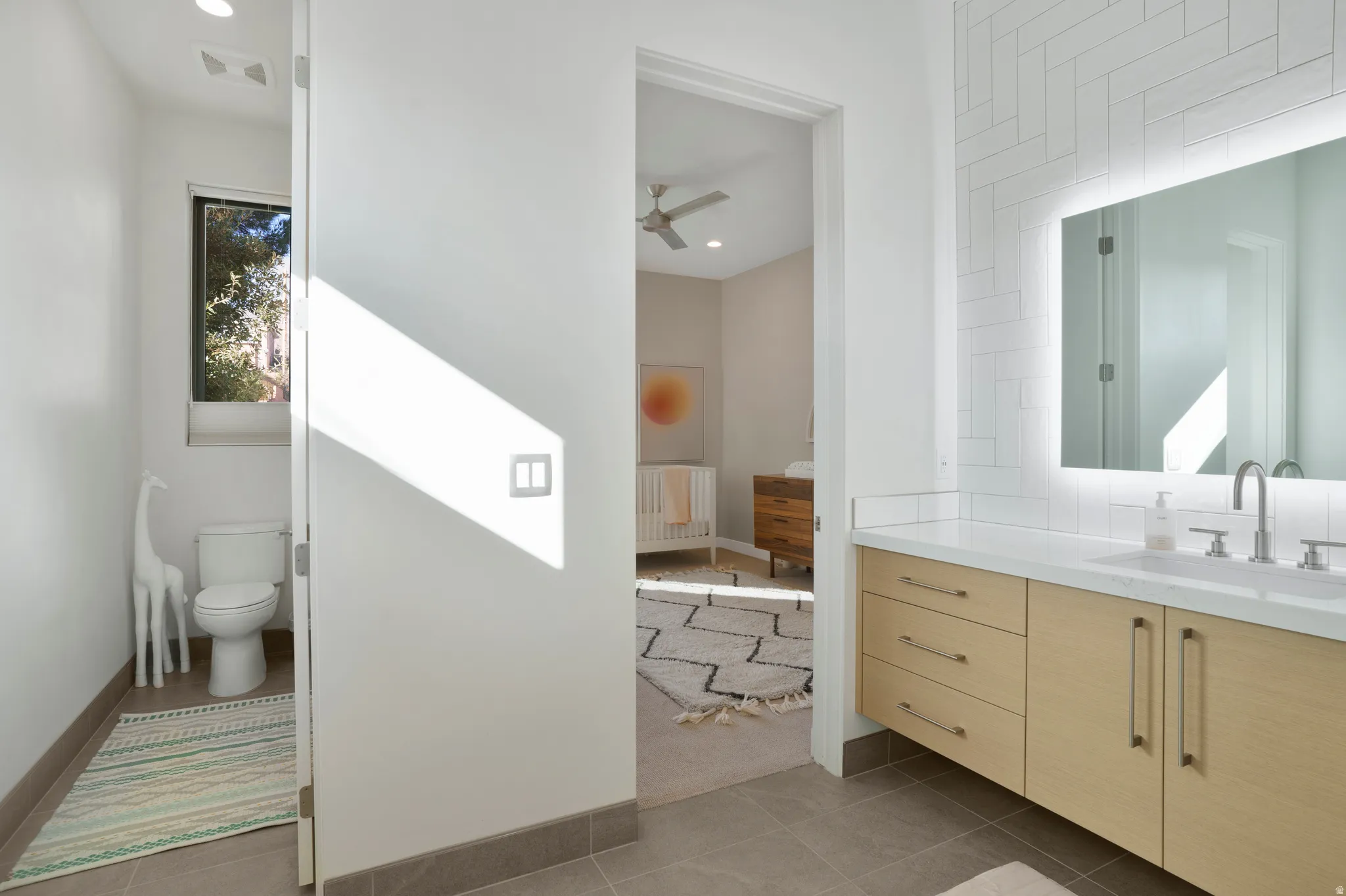 Bathroom with vanity, dark tile patterned flooring, a ceiling fan, and recessed lighting