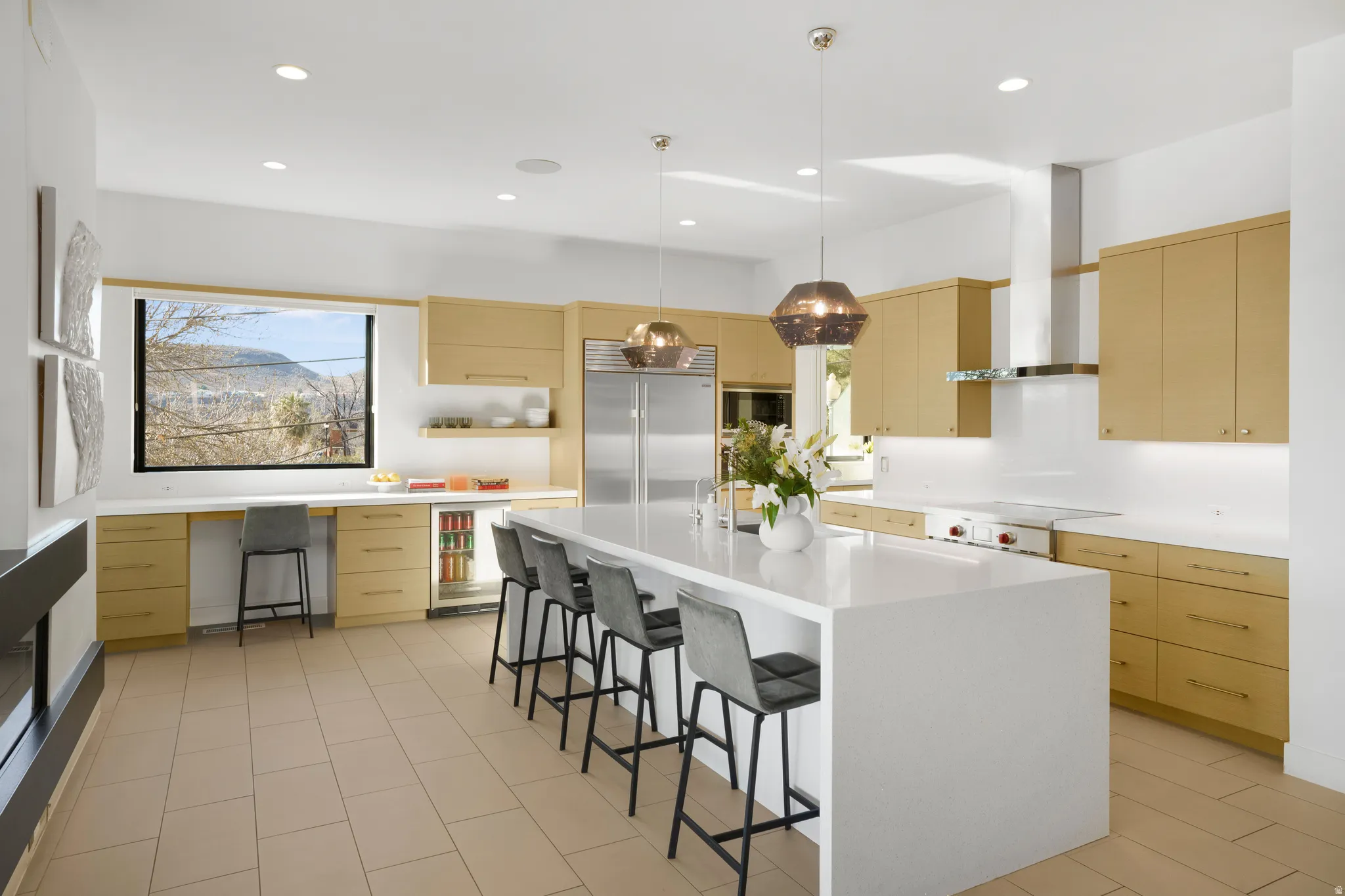Kitchen featuring pendant lighting, a breakfast bar area, built in appliances, a center island, and open shelves