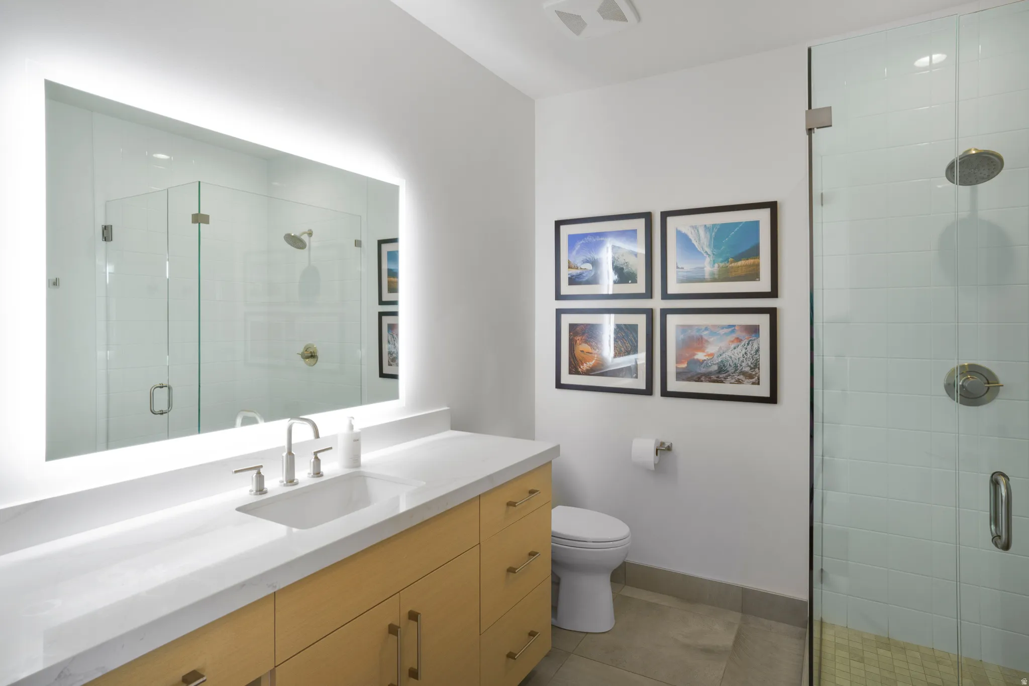Bathroom featuring vanity, a stall shower, and light tile patterned floors