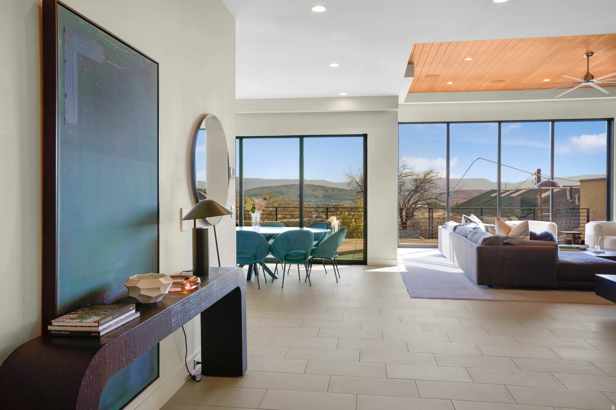 Living room with a mountain view, recessed lighting, and a ceiling fan