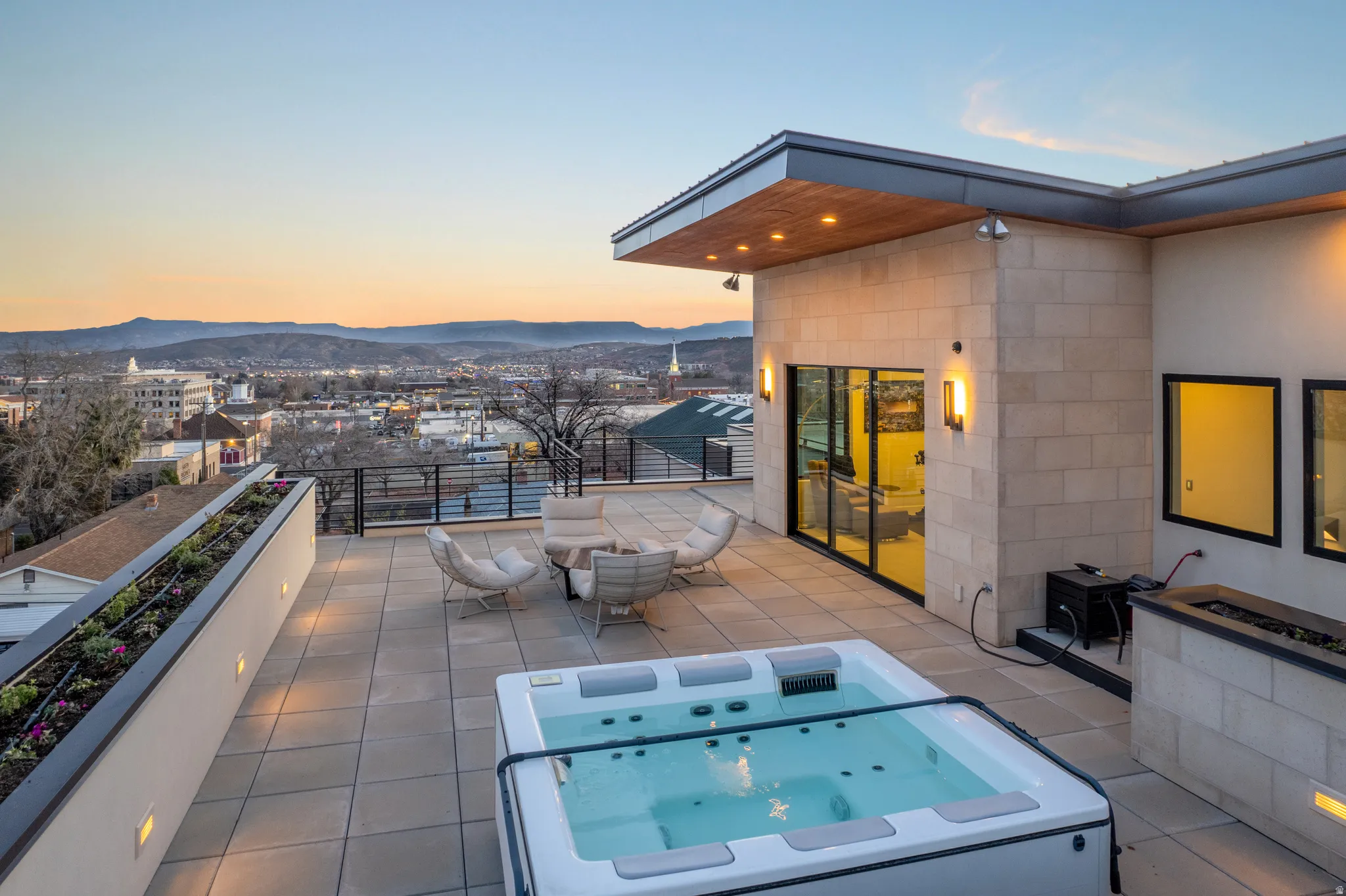 Patio terrace at dusk featuring a patio and a mountain view