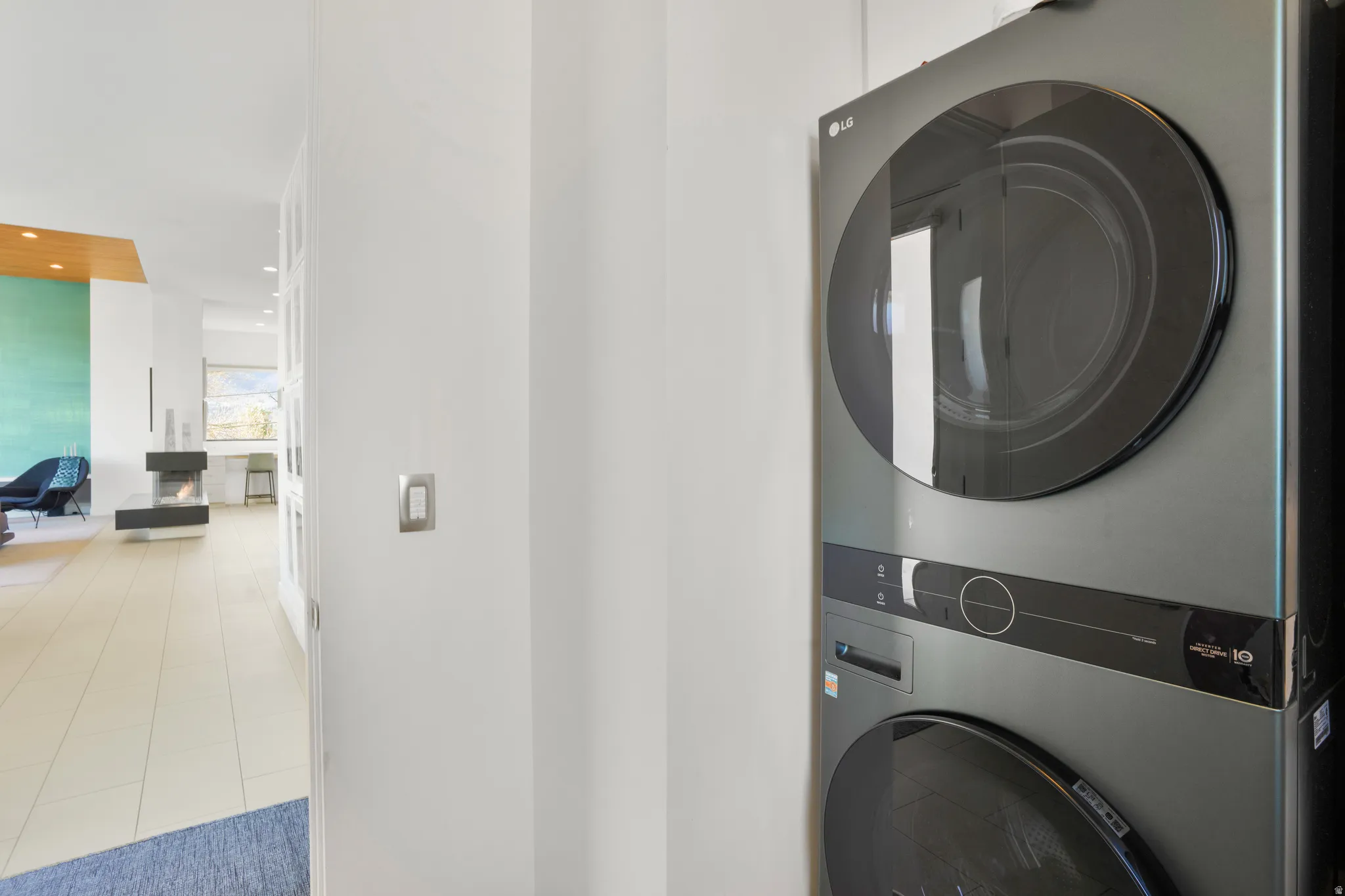 Laundry area featuring recessed lighting and stacked washer and dryer