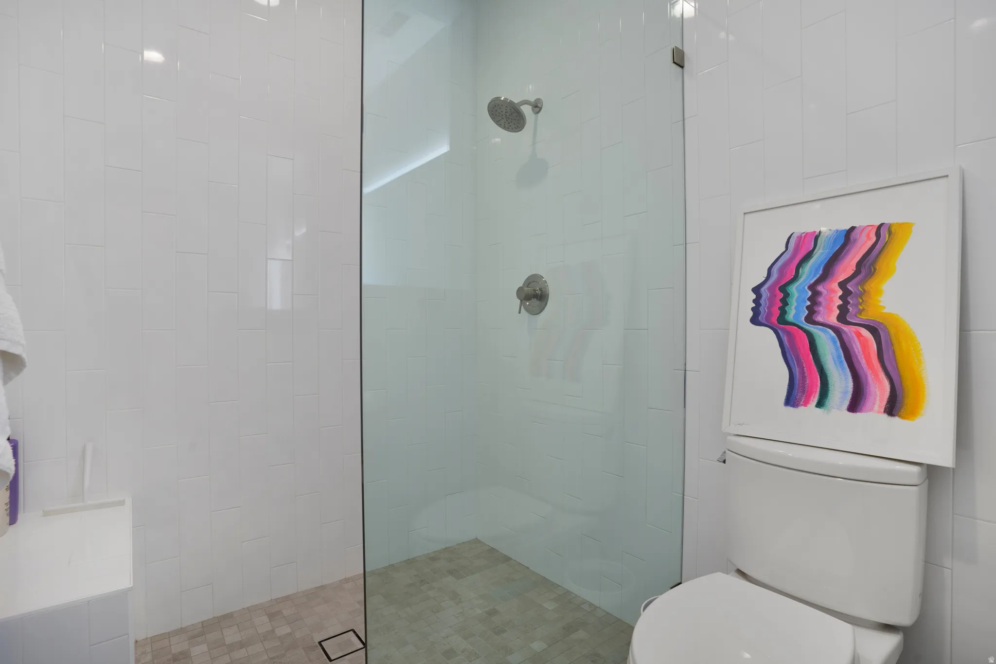 Bathroom featuring walk in shower and toilet