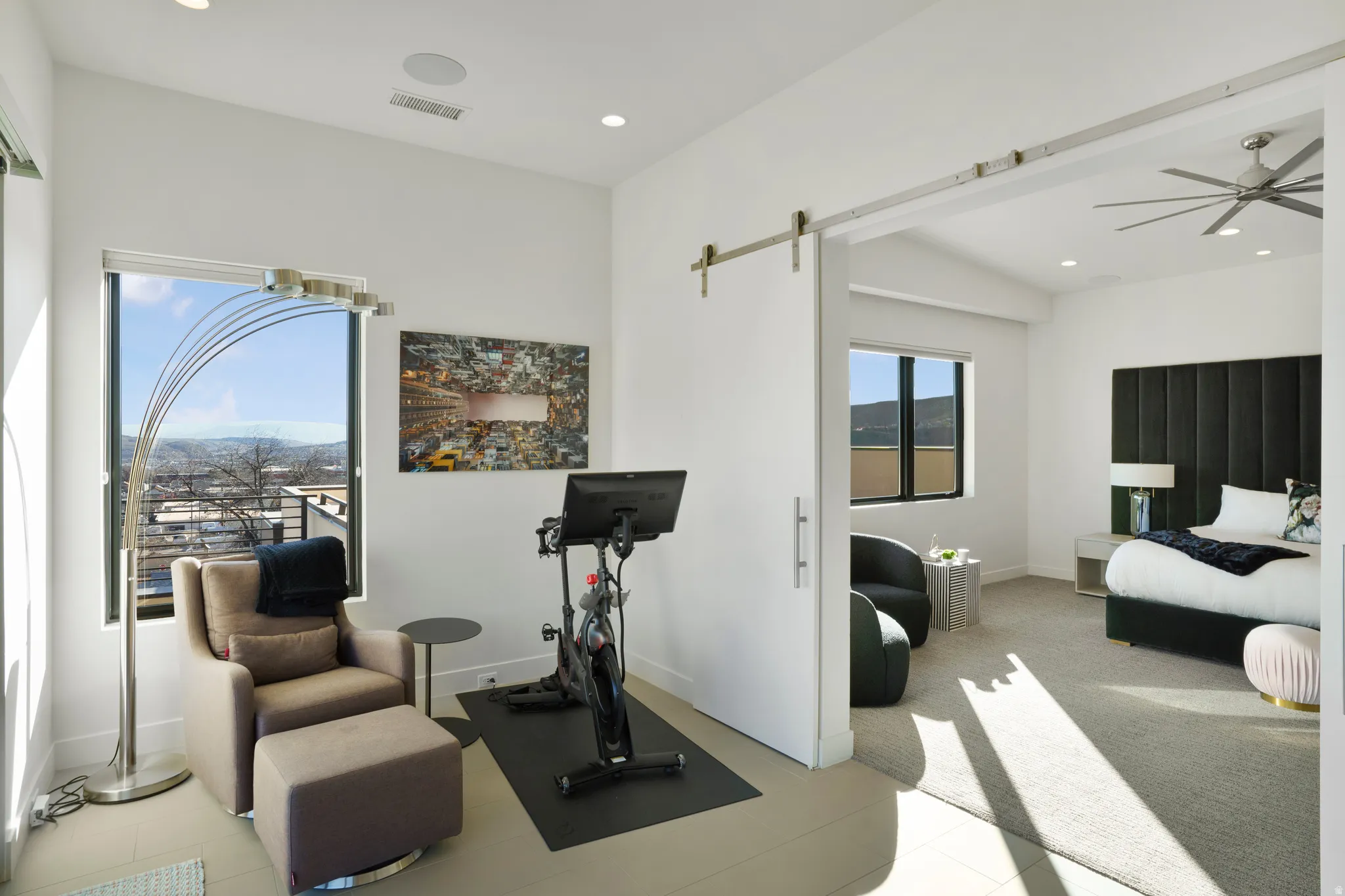 Workout area with a barn door, ceiling fan, and recessed lighting