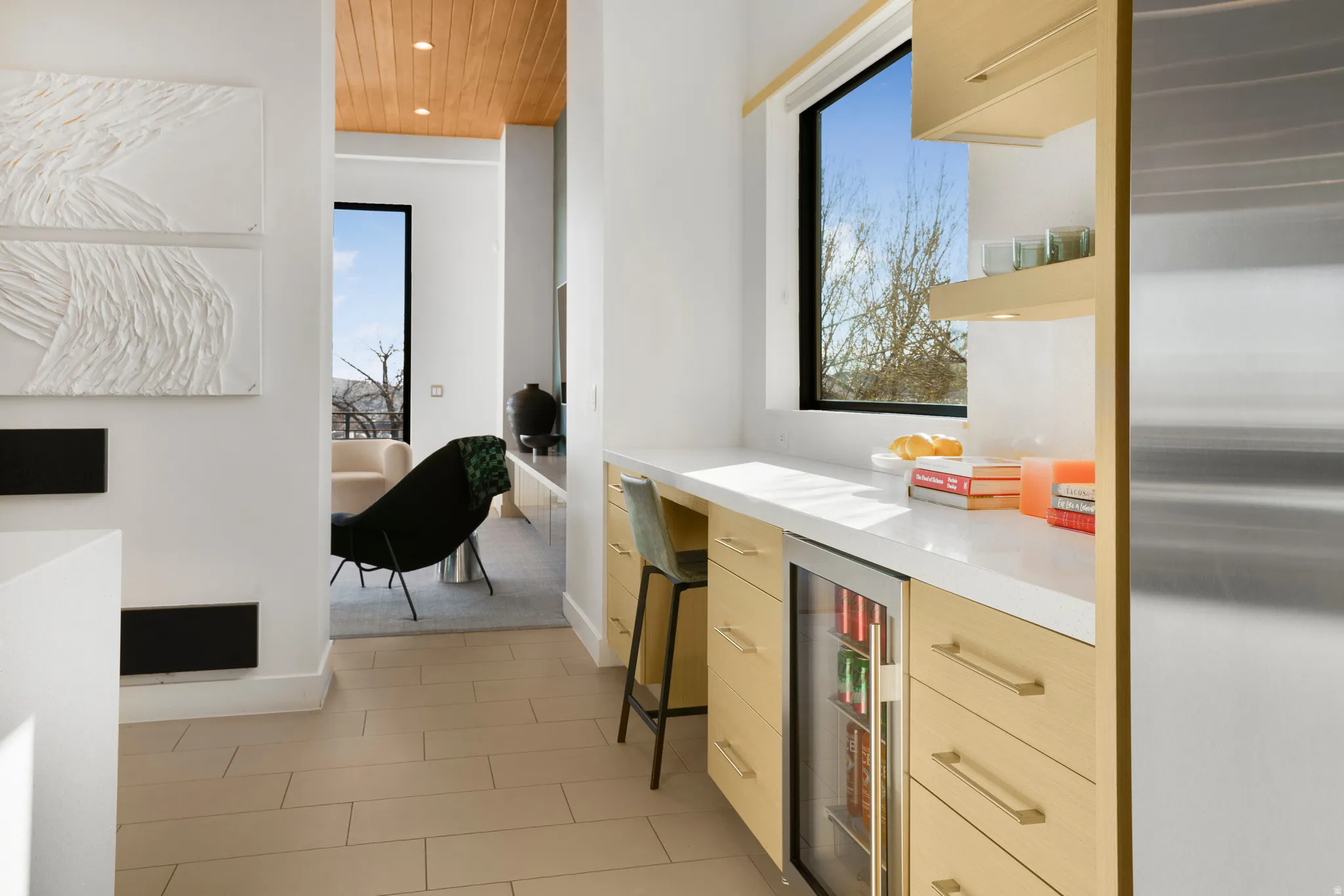 Bar with open shelves, beverage cooler, stainless steel fridge, light wood finish cabinetry, and wood ceiling