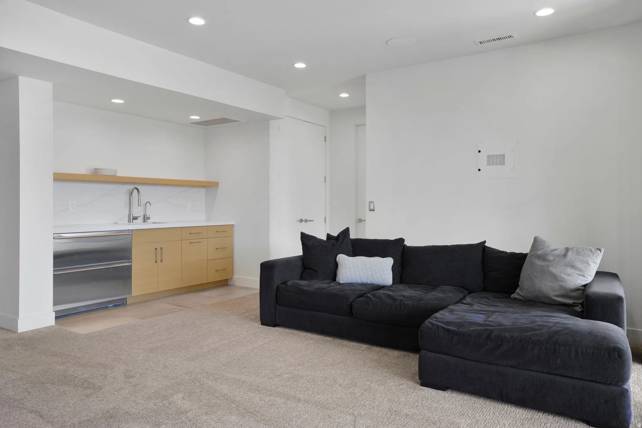 Living room with recessed lighting and light colored carpet