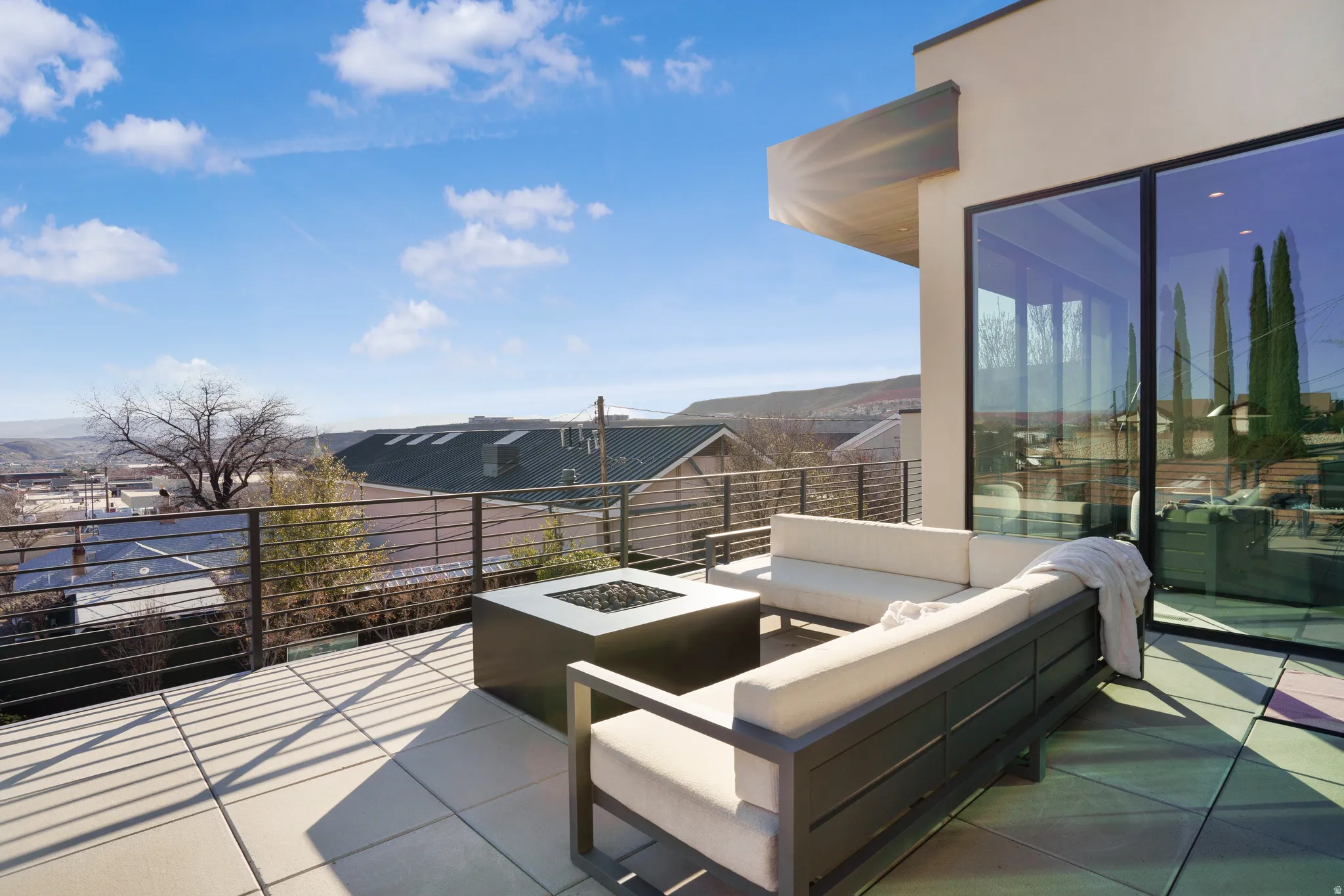 View of patio / terrace featuring an outdoor living space with a fire pit and a residential view