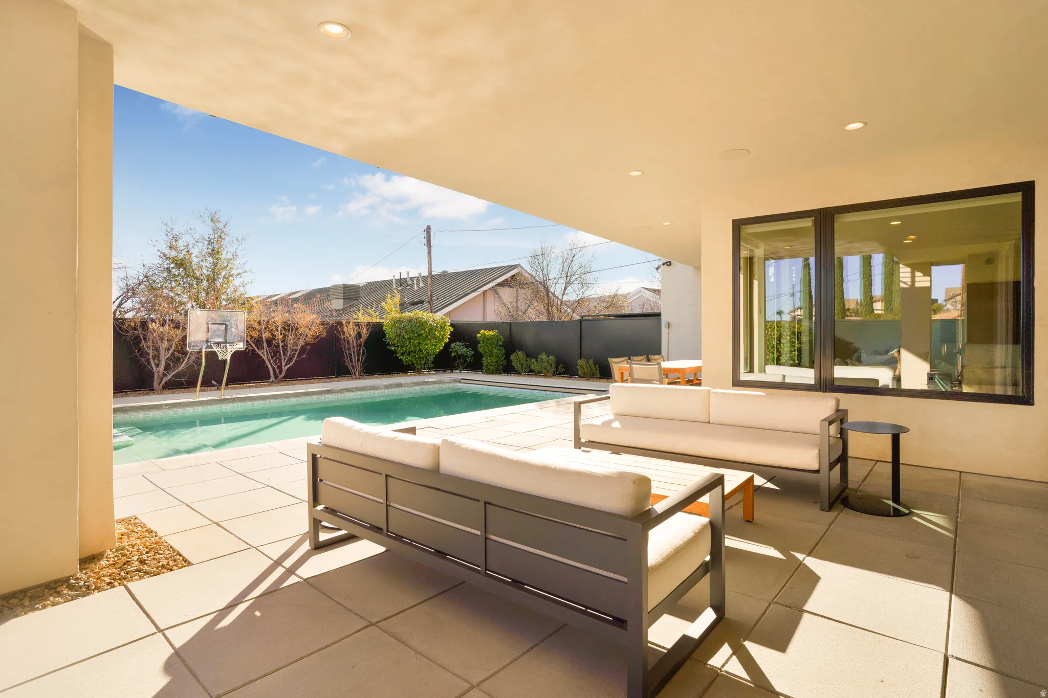 Fenced backyard with outdoor furniture and a patio