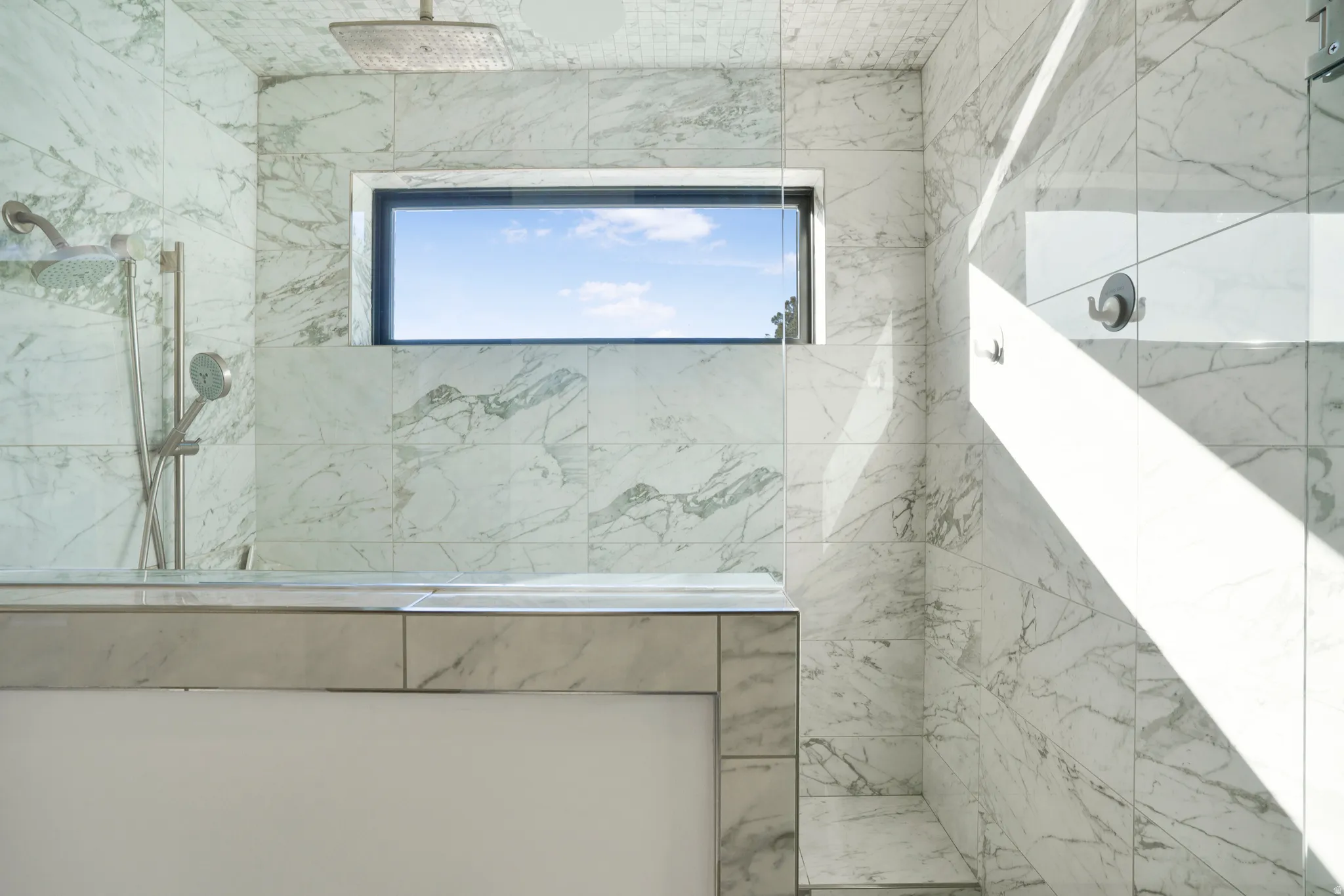 Bathroom featuring a marble finish shower