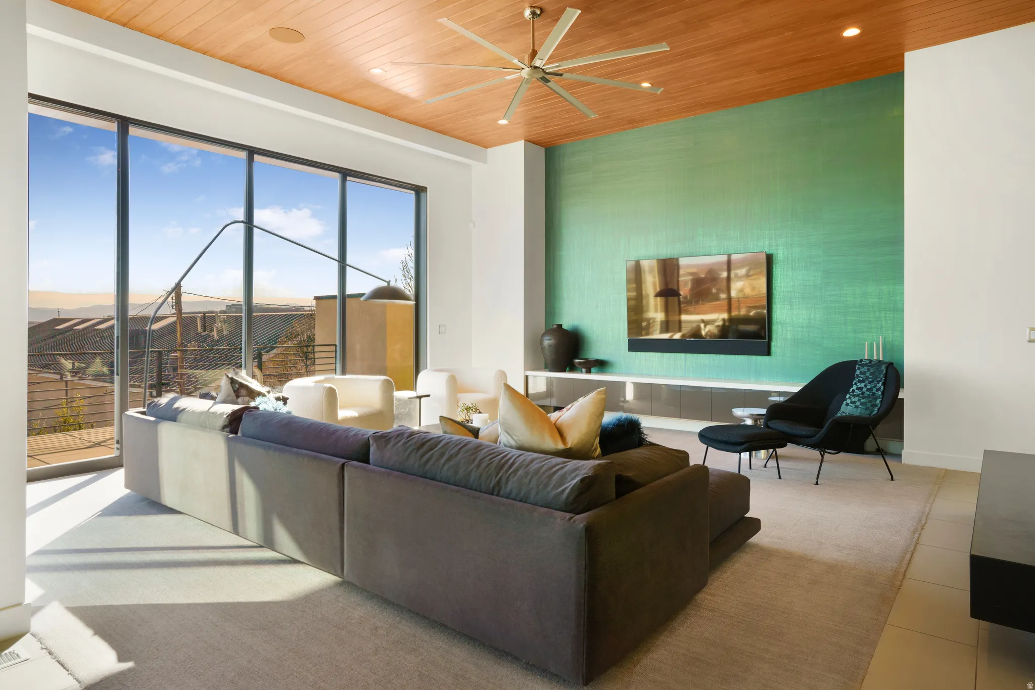 Living area featuring ceiling fan, wood ceiling, an accent wall, and recessed lighting
