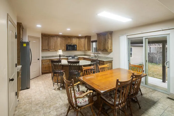 Dining space featuring recessed lighting and light stone finish flooring